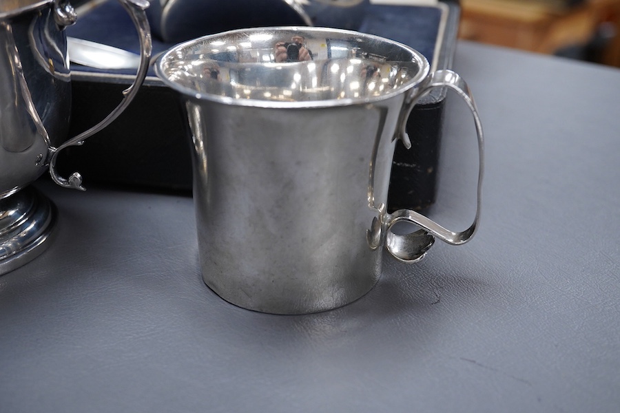 A George V Britannia standard silver mug, by Thomas Bradbury & Sons, Sheffield 1918, height 65mm, handle a.f., together with a 1930's silver porringer and a George V cased silver christening bowl and spoon, 13.2OZ.